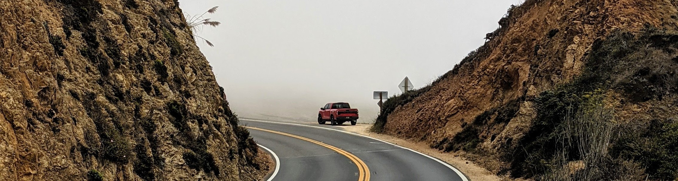 Company truck on a foggy coastal road near Big Sur, CA